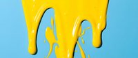 Yellow paint dripping and splashing against blue background, isolated for design use on merchandise, posters, and creative projects.