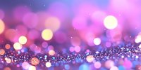 Magical pink and purple bokeh background with glowing golden particles and blurred lights creating dreamy atmospheric effect. Suitable for festive designs.