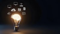 Glowing light bulb with technology icons representing innovation, creativity and digital solutions for business development and smart ideas.