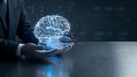Businessman holding glowing digital brain hologram with neural network connections representing artificial intelligence and machine learning technology.