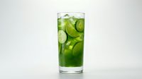 Refreshing green cucumber detox drink with ice slices in a tall glass, isolated on white background.