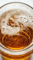 Overhead view of cola or cola-like beverage in glass with ice, bubbles, and carbonation swirls, suitable for beverage advertising, restaurant menus, and soft drink promotions.