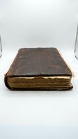 Antique leather-bound book with worn dark brown cover and aged yellowed pages, isolated on white background for design, education, library, or historical publication use.