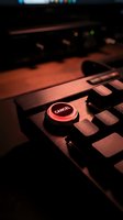 Red cancel button on computer keyboard in dramatic lighting with warm tones and shallow depth of field for technology and business concepts.
