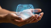 Hands holding glowing holographic gaming controller with futuristic blue light effects on dark background for technology and entertainment concepts.