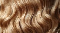 Luxurious wavy blonde hair texture with natural highlights and lowlights creating flowing pattern. Close up of healthy shiny hair strands for beauty and fashion design.