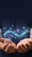 Hands holding glowing digital network with interconnected nodes and flowing cyan waves, representing data connection, technology innovation, and digital transformation for business solutions.