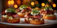 Gourmet beef tartare canapes with herbs and cream cheese on toasted bread, elegant appetizers for fine dining and holiday entertaining.