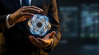 Businessman in suit holding glowing energy vortex between hands, futuristic technology concept with swirling light spiral on dark background.