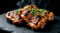 Grilled pork ribs with sesame seeds and herbs on slate board with steam rising, barbecue meat dish for restaurant menu and cooking content.