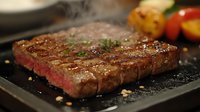 Grilled beef steak with herbs on slate plate, perfectly cooked medium-rare meat with seasoning and roasted vegetables for gourmet dining and culinary presentations.