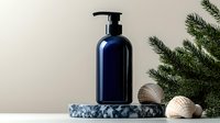 Navy blue cosmetic pump bottle on marble podium with seashells and pine branches, minimal spa composition against neutral background for beauty product.