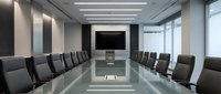 Modern corporate boardroom with glass conference table and black leather chairs in contemporary office interior for business meetings and presentations.