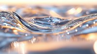 Clear water wave with golden sunset reflections and sparkling droplets creating dynamic fluid motion for wellness and nature concepts.