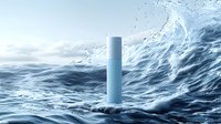 Minimalist cosmetic bottle mockup floating in dynamic ocean waves with water splashes and droplets against blue seascape background for skincare product presentation.