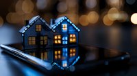 Miniature houses with glowing windows and LED lights reflecting on dark surface, creating magical bokeh effect and mirror reflection. Cozy holiday atmosphere.