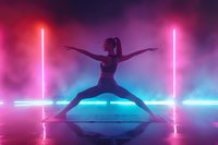 Athletic woman in warrior yoga pose silhouetted against vibrant neon lights and fog, creating dynamic composition with pink and blue gradient background.