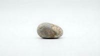 Single smooth gray granite stone pebble isolated on white background for zen meditation garden design spa wellness natural decoration elements.