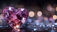 Pink crystal heart on dark reflective surface with soft bokeh lights in background creates romantic mood for Valentine's Day and love themes.