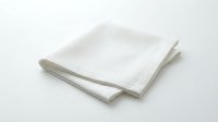 Folded white cotton napkin on a white background, isolated for design use. Clean, minimalist textile product shot for home, dining, and lifestyle concepts.