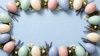 Pastel colored Easter eggs arranged in decorative border frame with dried lavender flowers and small white blooms on soft blue background.