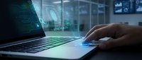 Professional using laptop with holographic data visualization and digital interface in modern office environment for business analytics and technology solutions.