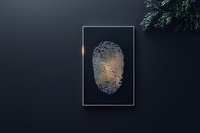 Glowing digital fingerprint scan on dark background with biometric identification pattern and pine branch decoration. Modern security concept.