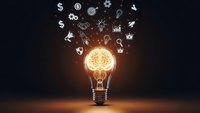Glowing light bulb with business icons floating above on dark background representing innovation, creativity and entrepreneurship concepts for marketing.