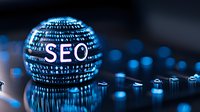 Digital sphere with SEO text and binary code pattern glowing in blue light against dark background with reflective surface and bokeh effects.