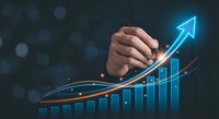 Business growth concept with hand drawing upward arrow over rising bar chart on dark background with bokeh lights for financial success presentations.