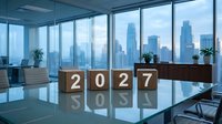 Wooden cubes with numbers 2027 on a glass conference table in a modern office with city skyline view, symbolizing future business planning.