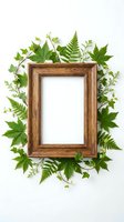 Wooden frame surrounded by fresh green leaves, ferns, and botanical foliage on white background. Ideal for nature-themed designs, eco-friendly projects, and creative layouts.