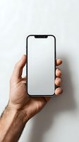 Male hand holding modern smartphone with blank white screen against neutral background. Perfect mockup for app or website design presentation.