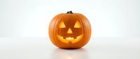 Carved orange pumpkin jack-o-lantern with glowing triangular eyes and smiling mouth on white background. Halloween decoration for autumn celebrations.