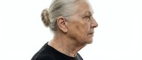 Senior woman with gray hair in profile, wearing black shirt against white background, suitable for healthcare, aging, wellness and lifestyle editorial use.