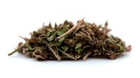 Dried herbal tea blend with green and brown leaves isolated on white background for natural wellness and organic beverage preparation.