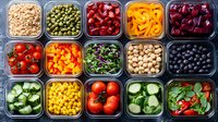 Colorful meal prep containers filled with fresh vegetables, legumes, beans and healthy ingredients arranged in organized grid pattern for balanced nutrition.