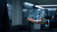 Businessman holding digital holographic interface with data analytics icons and charts in modern office environment for technology solutions.