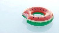 Inflatable watermelon pool float ring with pink and green colors, featuring realistic seed details, perfect for summer swimming and beach parties.