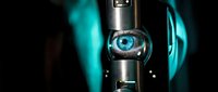 Futuristic cyborg eye with glowing blue iris and metallic components on dark background, suitable for sci-fi, technology, and artificial intelligence projects.
