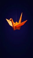 Orange origami paper crane suspended on string against dark blue gradient background symbolizing peace hope and Japanese traditional art.
