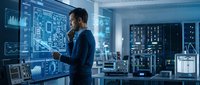 Young Asian male engineer analyzing holographic circuit diagrams in futuristic control room with digital displays and advanced technology systems.