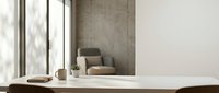 Minimalist modern workspace with white desk, coffee cup and plant in bright natural light from large windows creating clean productive office environment.