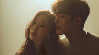 Young Asian couple sharing intimate moment in warm golden light with soft romantic atmosphere and tender embrace.