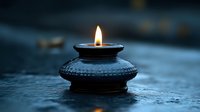 Lit oil lamp with glowing flame on wet surface, creating warm light in dark moody atmosphere. Suitable for spirituality, meditation, and atmospheric design projects.