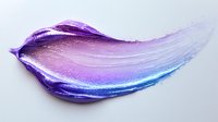 Purple and blue gradient makeup smear with shimmer particles isolated on white background for cosmetic and beauty design projects.