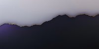 Dramatic mountain silhouette at twilight with purple and pink sky gradient creating moody atmospheric landscape for nature and travel designs.