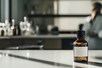 Brown glass bottle with blank label on white counter in modern laboratory setting, soft natural lighting creates dramatic shadows, blurred scientific equipment background.