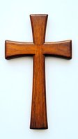 Wooden cross with rich brown finish isolated on white background, featuring classic Christian design and natural wood grain texture. Religious wall decor element.