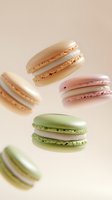 Colorful French macarons floating on soft pink background showcasing delicate almond cookies in pastel shades for bakery and confectionery designs.